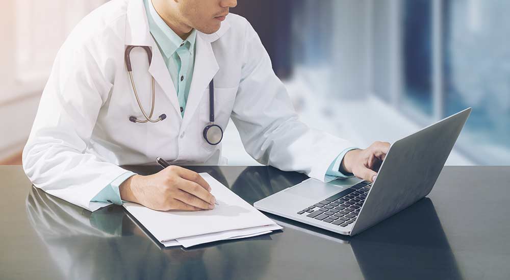 doctor doing work on laptop