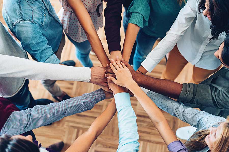 Group of people with their hands together