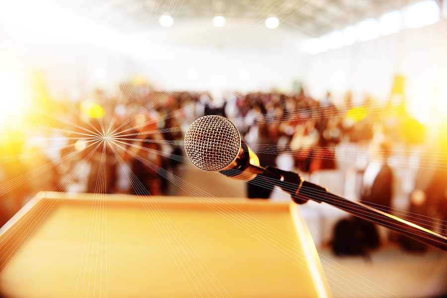 microphone and podium in front of a crowd