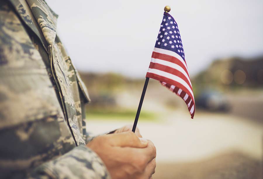 veteran holding a small U.S.A flag