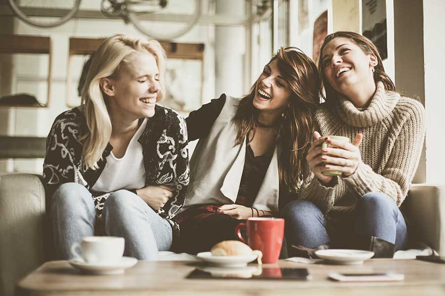Friends in coffee shop laughing