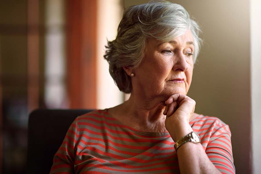 senior woman looking out window