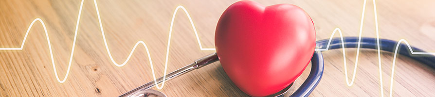 stethoscope on table with plush heart