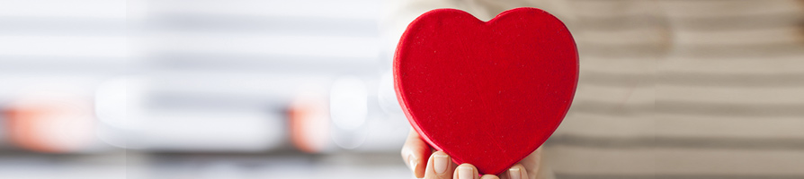 hand holding a heart box