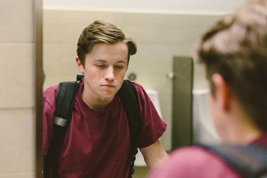 boy in front of bathroom mirror