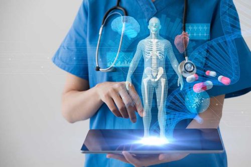 nurse holding tablet with electronic model of a skeleton