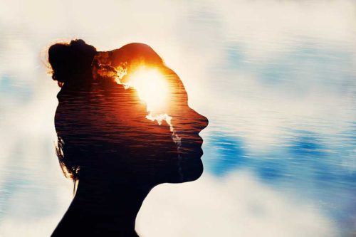 silhouette of woman with sun shining