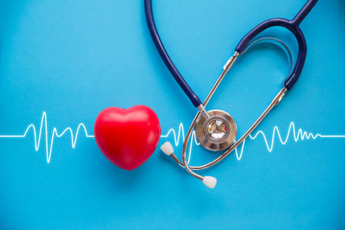 plush heart and stethoscope over a vital signs line