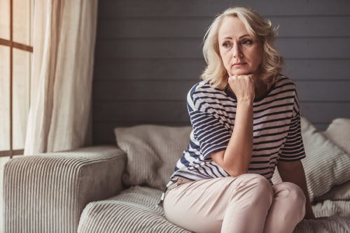 woman on couch looking out a window