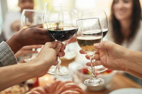 Friends toasting wine at dinner