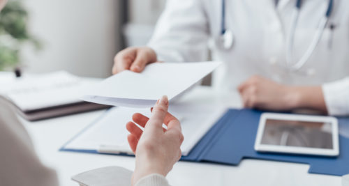 Physician showing document to patient
