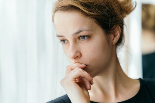 Woman gazing at camera by window