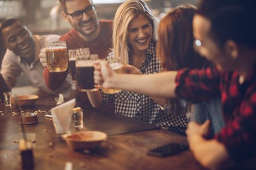 Friends celebrating together with beer
