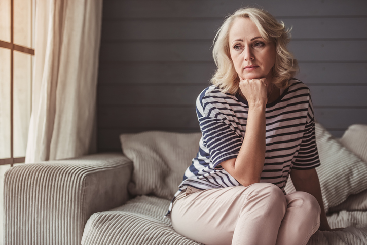 Woman in contemplation on couch