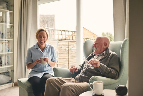 Woman in uniform, helping senior
