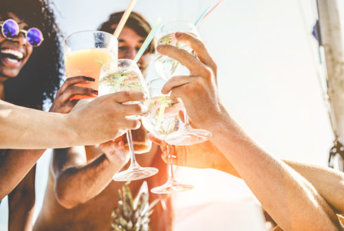 Friends celebrating with drinks on a beach