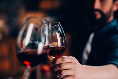 Man toasting with wine glasses