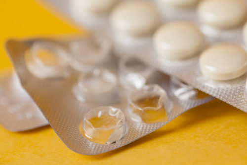 Pack of pills featuring a prominent white pill in the center
