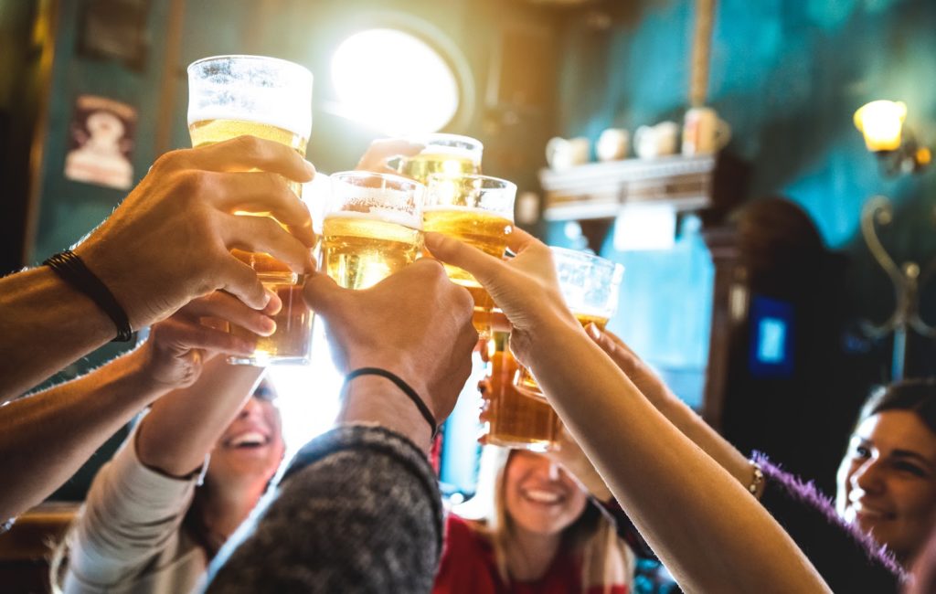 Friends toasting beer glasses together