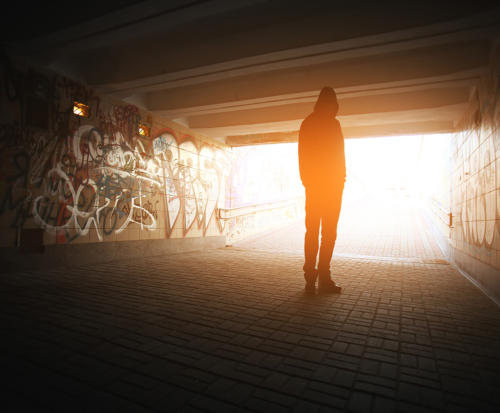 Silhouette of man in tunnel