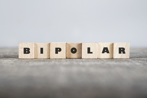 Wooden block letters spelling out bipolar on a table.