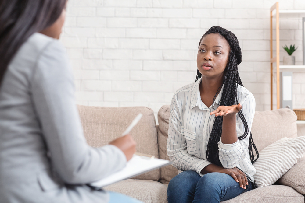 A young african-american woman talking to her therapist.