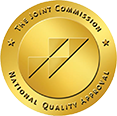 A gold graphic for The Joint Commision providing National Quality Approval to Beach House Recovery Center.