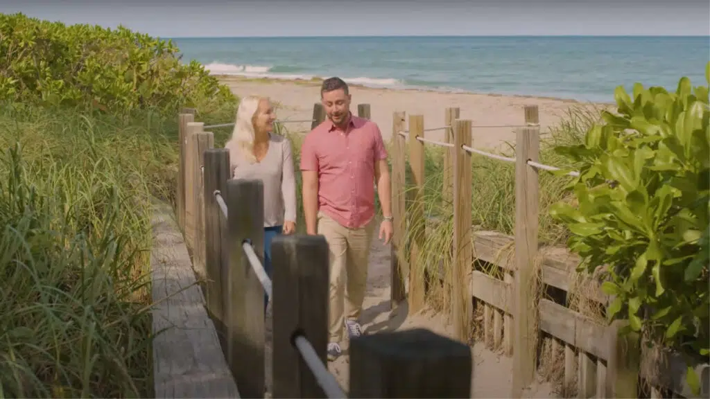 Pair walking along the beach trail
