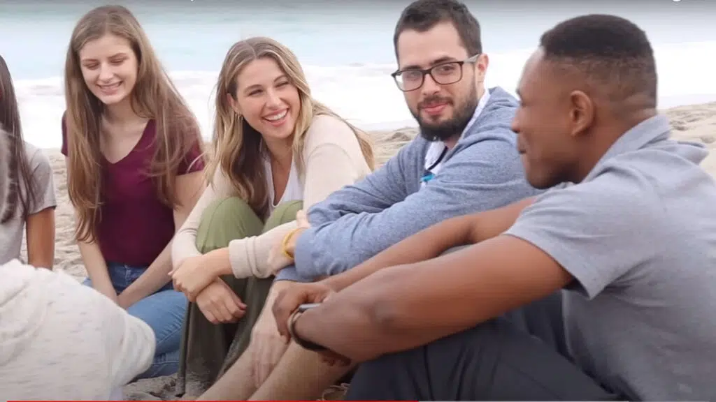 Group sitting on Beach talking
