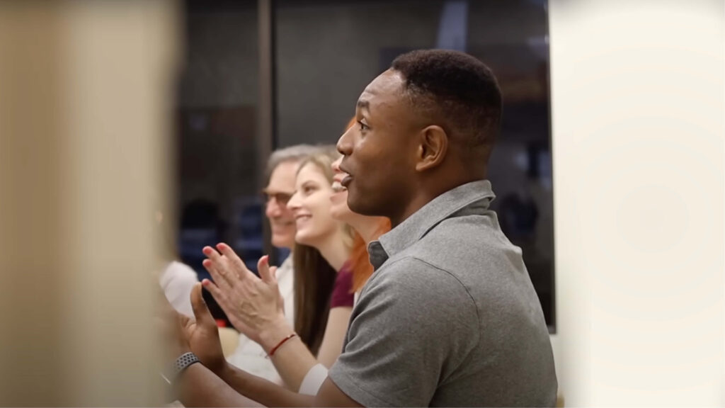 Man applauding before an audience