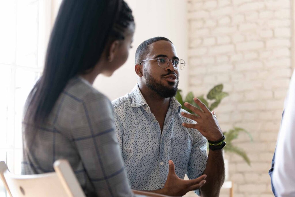 Man expressing himself in front of a group