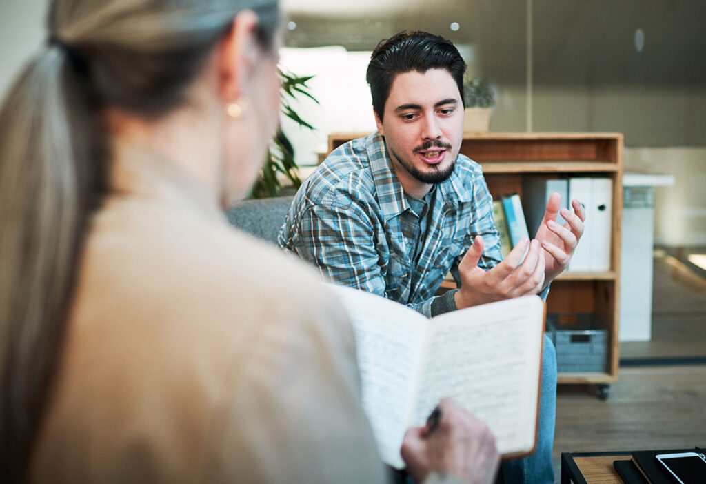 Man speaking to female therapist