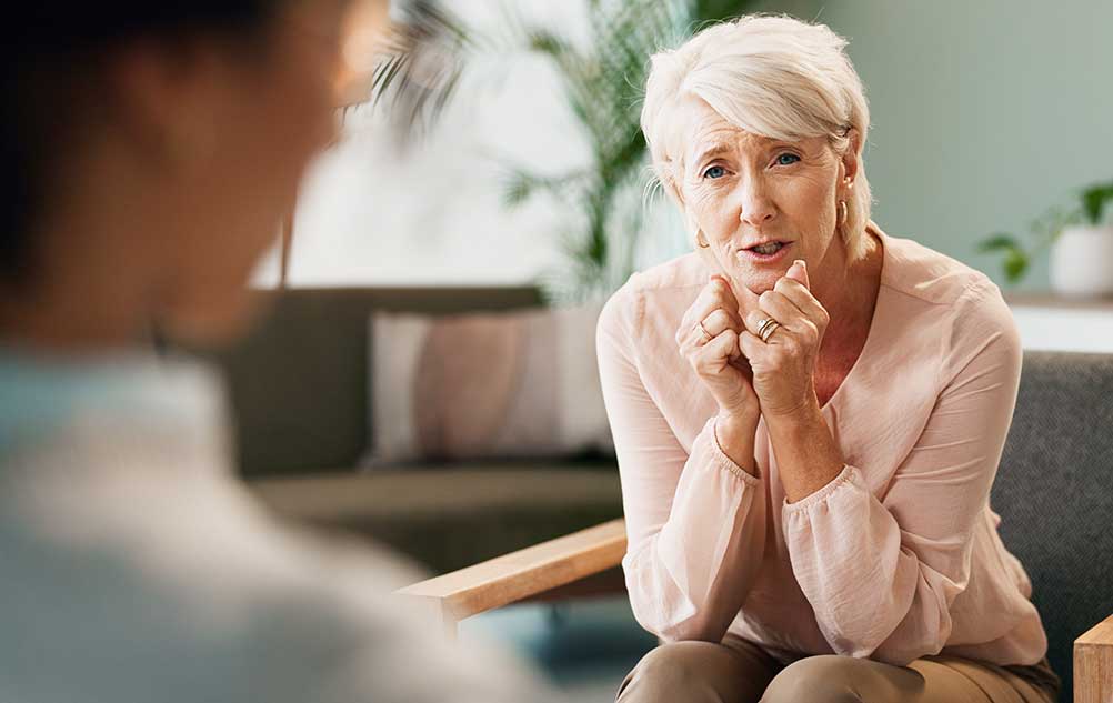 Senior woman speaking with therapist