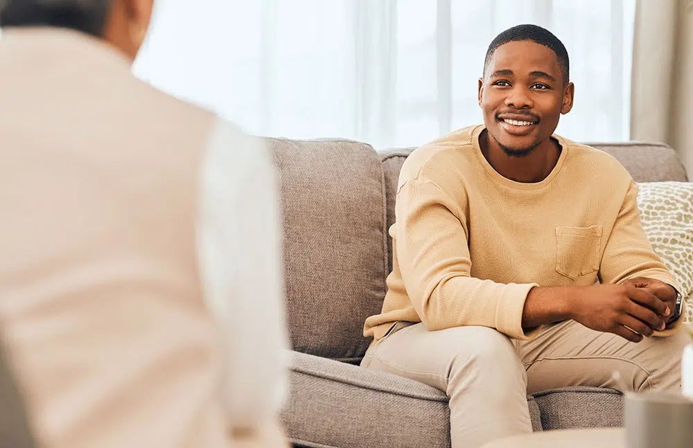 Man smiling at therapist