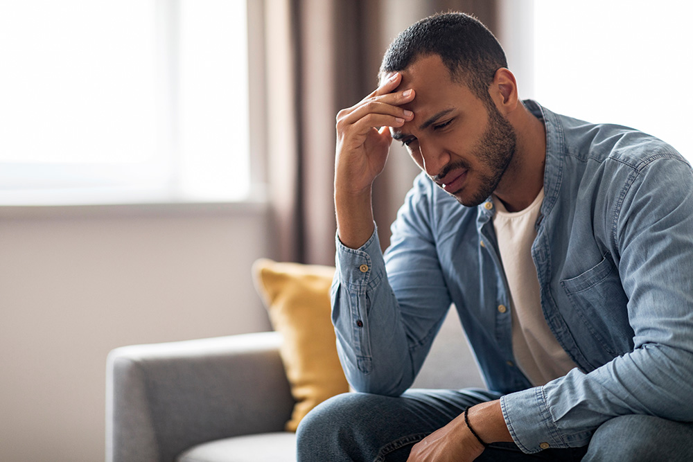 Man sitting with worried look