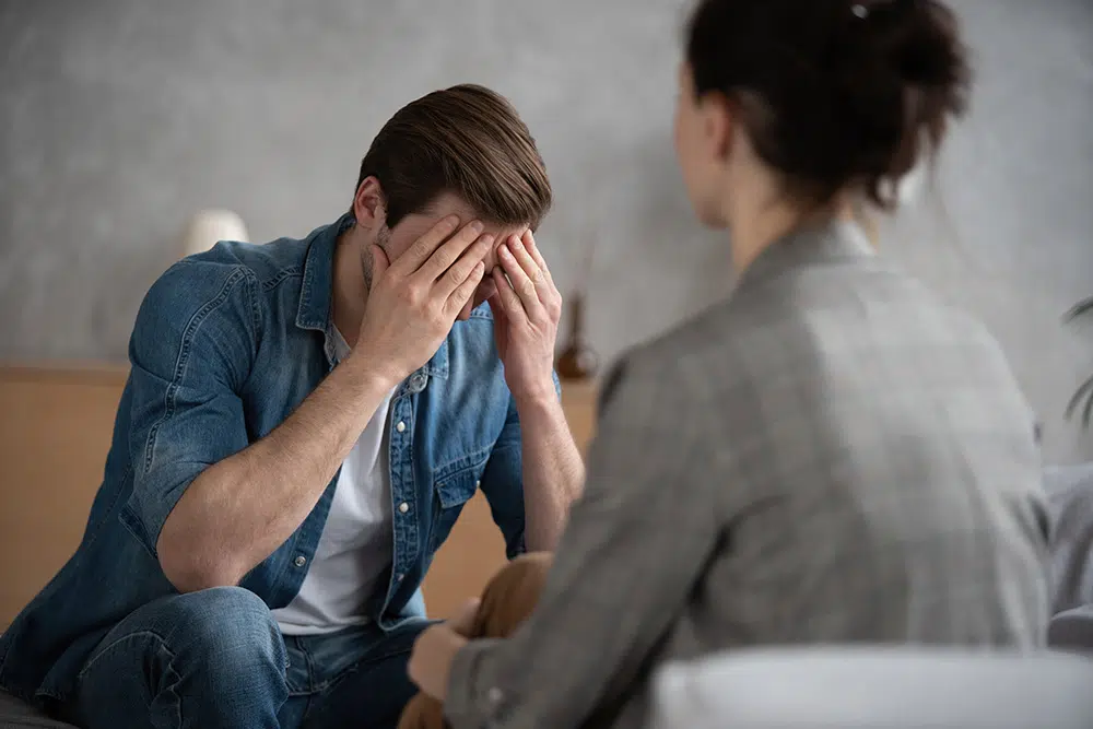 Psychologist talking with patient on therapy session.